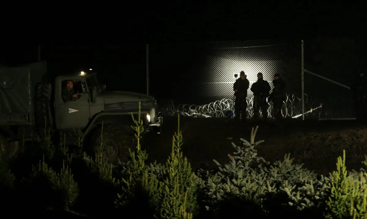 Hungarian soldiers stand by a fence put on the border with Croatia near the village of Zakany, Hungary, on Oct. 17, 2015. Hungary shut down its border with Croatia to the free flow of migrants on Saturday, a move experts say could leave thousands of people on their way to western Europe stranded in the small Balkan nation. (AP Photo/Petr David Josek)