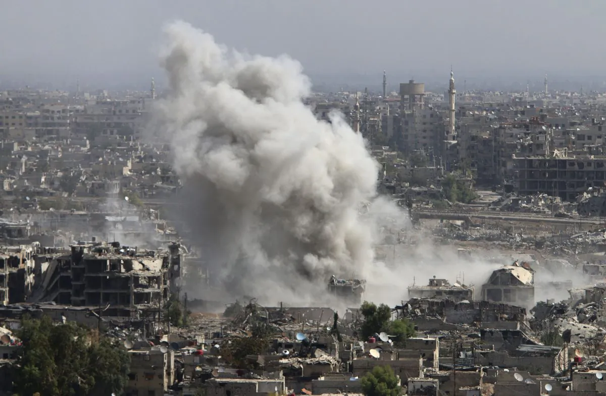 Smoke rises after shelling by Syrian army in Jobar, Damascus, Syria, on Oct. 14, 2015. (Alexander Kots/Komsomolskaya Pravda via AP)
