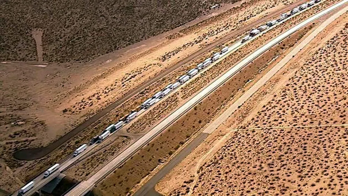 Hundreds of trucks and cars stranded on State Highway 58 near Mojave, Calif., on Oct. 16, 2015, after torrential rains Thursday caused mudslides that carried away vehicles and closed roads about 70 miles north of Los Angeles. Officials said no deaths or injuries were reported. (KABC-TV via AP)