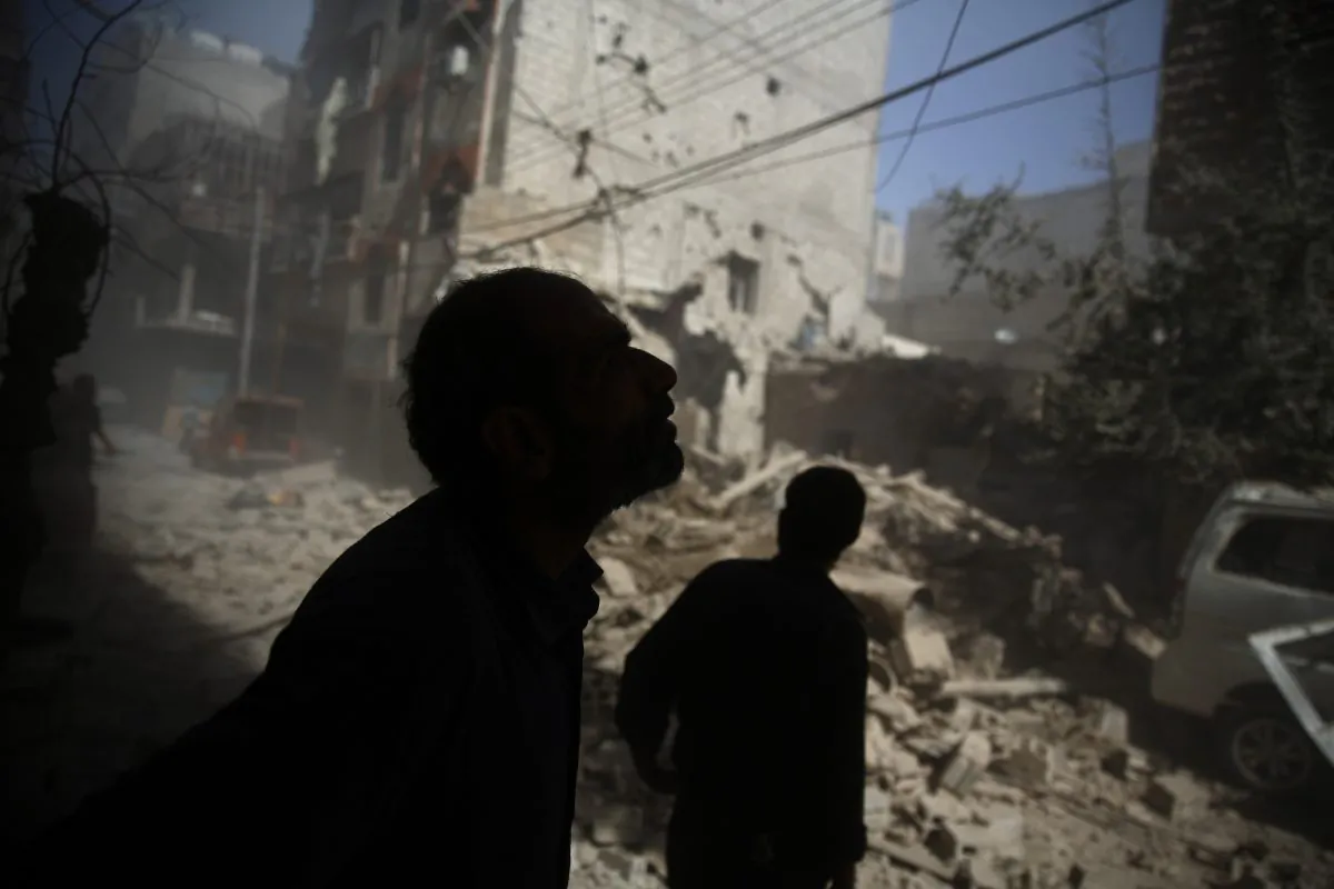 Syrians look at the damage following airstrikes on the rebel-held area of Douma, east of the capital Damascus, on Oct. 2, 2015. (Abd Doumany/AFP/Getty Images)