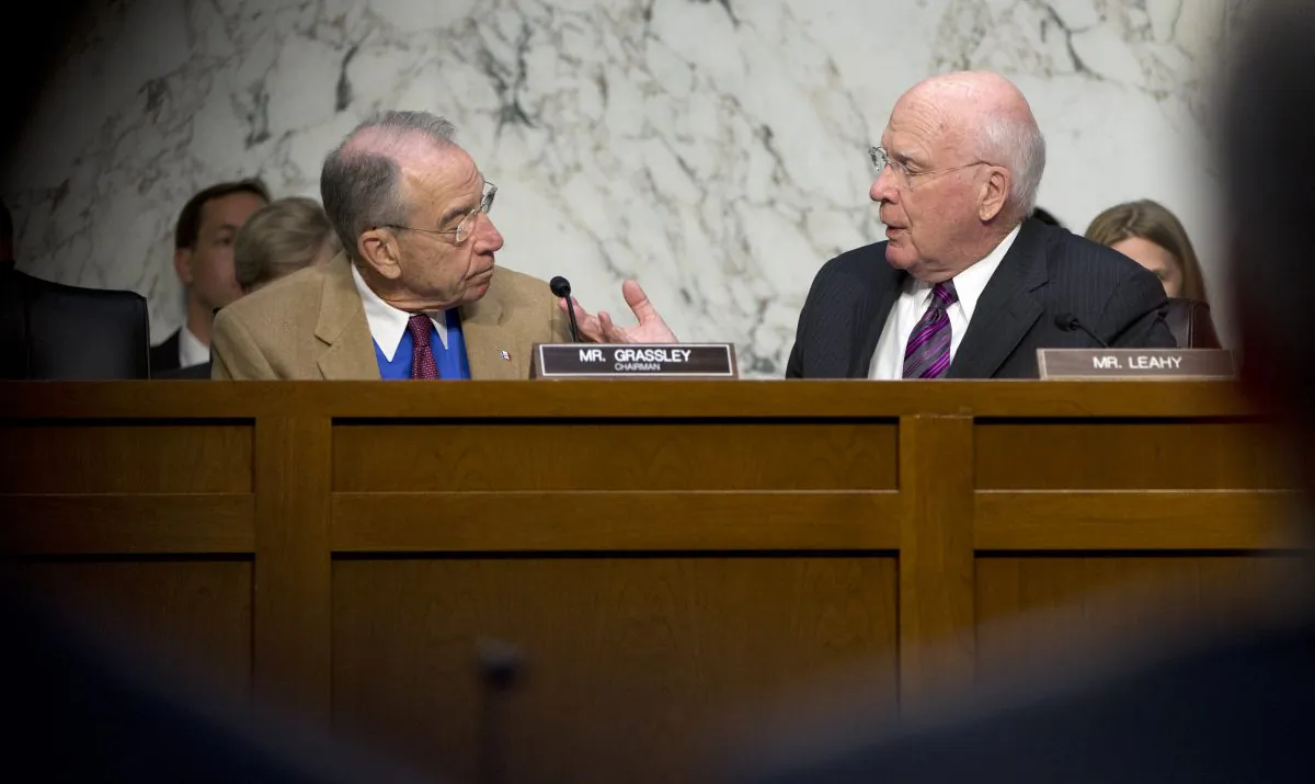 Senate Judiciary Committee Chairman Sen. Charles Grassley, R-Iowa, left, and the committee's ranking member Sen. Patrick Leahy, D-Vt. talk on Capitol Hill in Washington, Monday, Oct. 19, 2015, during the committee's hearing on the Sentencing Reform and Corrections Act of 2015.  (AP Photo/Carolyn Kaster)