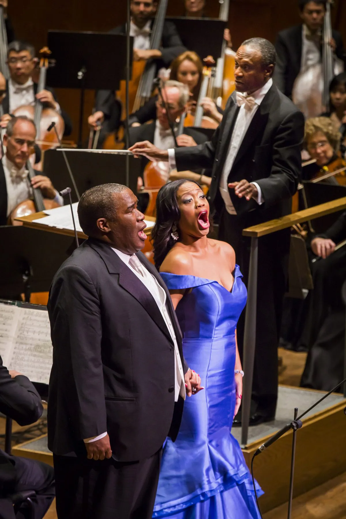 Thomas Wilkins conducts the New York Philharmonic in In Their Footsteps: Great African American Singers and Their Legacy with soloists Eric Owen, Janai Brugger, Laquita Mitchell, Deborah Nansteel, Russell Thomas and Dorothy Maynor Singers of the Harlem School of the Arts at David Geffen Hall, 10/14/ 15. Photo by Chris Lee