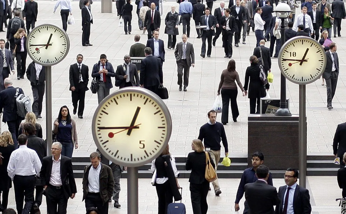 City workers walk through London's Canary Wharf on Sept. 16, 2008. (Shaun Curry/AFP/Getty Images)