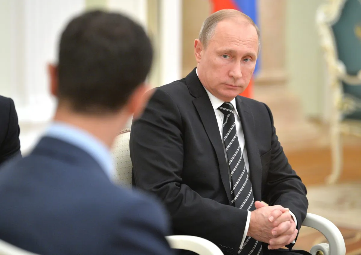 Russian President Vladimir Putin attends a meeting with Syrian President Bashar Assad (back to the camera), in the Kremlin in Moscow, Russia, on Tuesday. (Alexei Druzhinin/RIA-Novosti via AP)