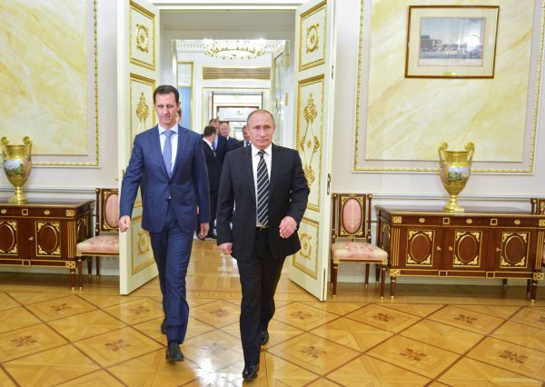 Russian President Vladimir Putin (R) and Syria President Bashar Assad arrive for their meeting in the Kremlin in Moscow, on Tuesday. (Alexei Druzhinin/RIA-Novosti via AP)