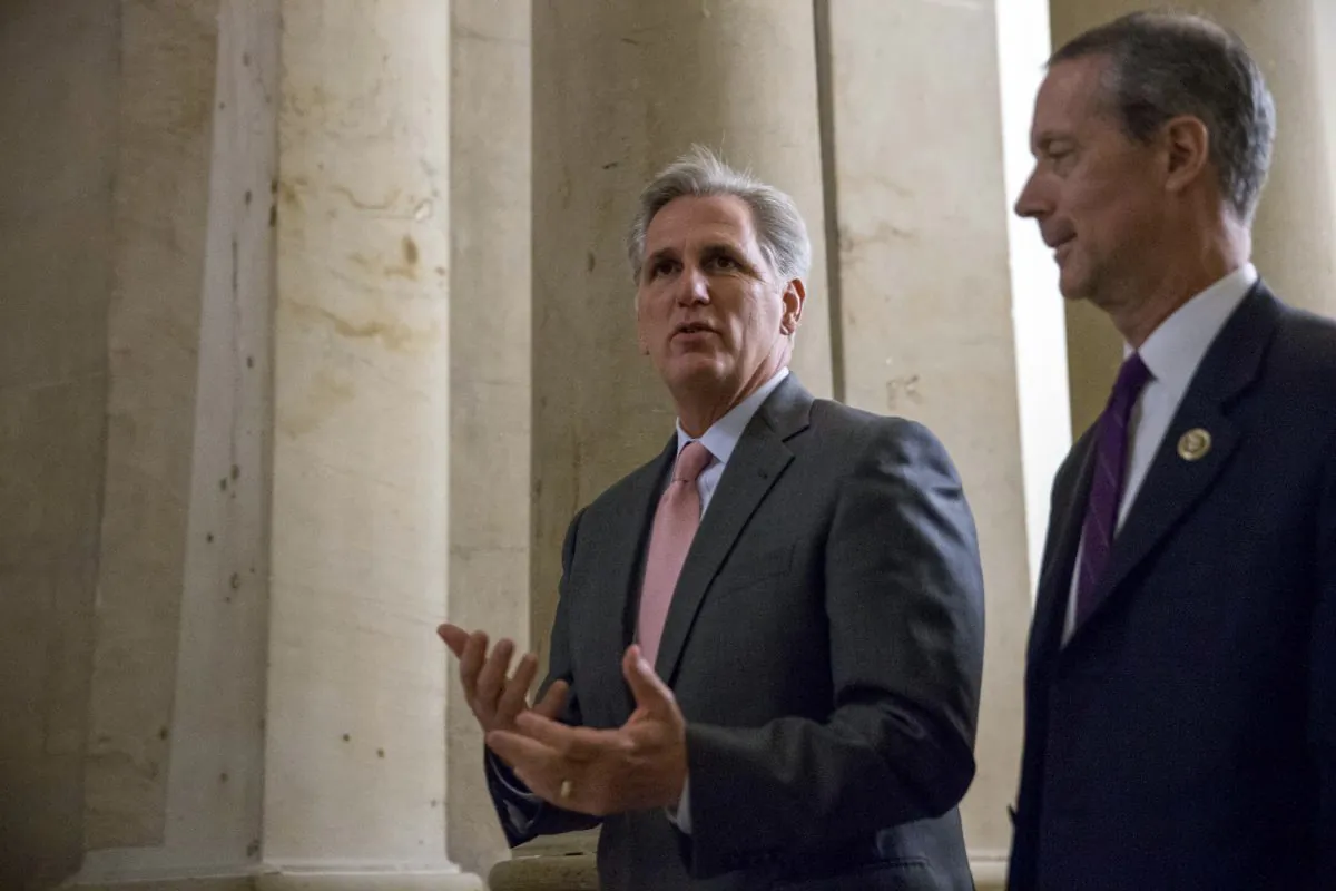 House Majority Leader Kevin McCarthy of Calif. (C), accompanied by House Armed Services Committee Chairman Rep. Mac Thornberry (R-Texas) (R), walks to the House floor to vote on a stopgap spending bill to avert a government shutdown on Capitol Hill in Washington, D.C., on Sept. 30, 2015. Just hours before a midnight deadline, a bitterly divided Congress approved the stopgap spending bill to keep the federal government open, but with no assurance there won't be yet another shutdown showdown in December. (AP Photo/Andrew Harnik)