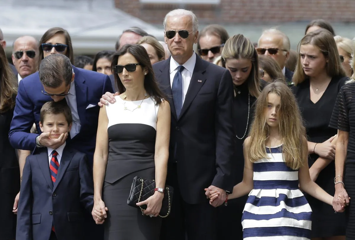 Hunter Biden (L) kisses his nephew Hunter, son of Beau Biden, as they stand with Beau's widow Hallie (3L), then-Vice President Joe Biden and Beau's daughter Natalie before his funeral, at St. Anthony of Padua Roman Catholic Church in Wilmington, Del., on June 6, 2015. (Patrick Semansky/AP Photo)