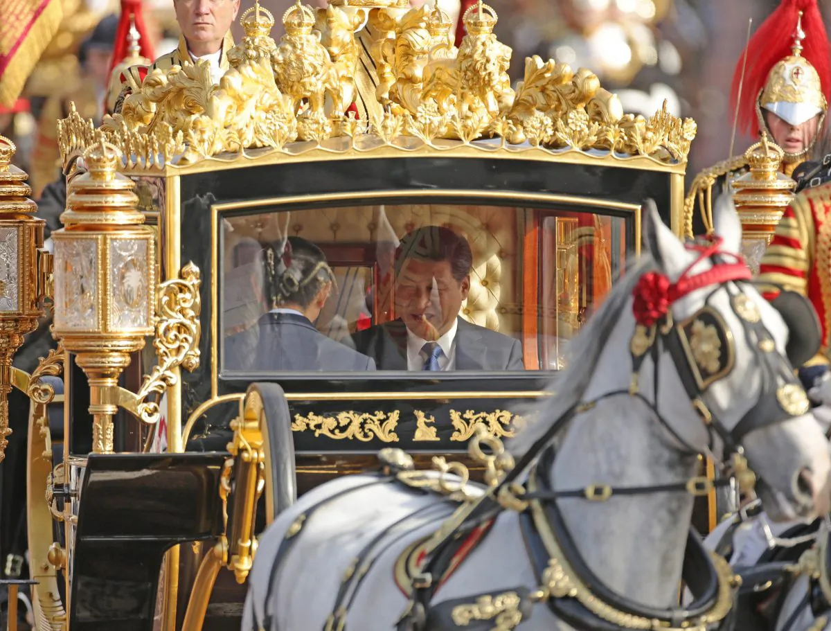 Chinese Communist Party leader Xi Jinping and Queen Elizabeth II ride in the Diamond Jubilee State Coach along The Mall after a ceremonial welcome on his first state visit to the UK in London on Oct. 20, 2015. (Yui Mok/WPA Pool/Getty Images)