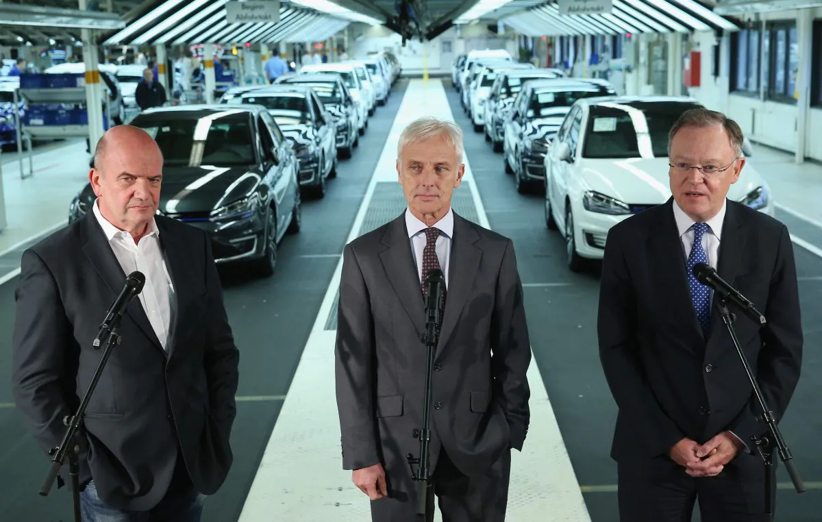 New Volkswagen Group Chairman Matthias Mueller (C), Volkswagen Work Council head Bernd Osterloh (L) and Lower Saxony Governor Stephan Weil hold a press conference at the assembly line of the Volkswagen factory on Oct. 21 in Wolfsburg, Germany. It was recently exposed that Volkswagen vehicles had software to dupe smog tests. (Photo by Sean Gallup/Getty Images)
