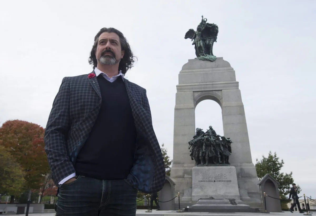 Martin Magnan poses for a photo in front of the National War Memorial in Ottawa on Oct. 21, 2015. Magnan was among six people who risked their lives to aid mortally wounded soldier Cpl. Nathan Cirillo, who was shot by Michael Zehaf Bibeau last October. (The Canadian Press/Adrian Wyld)