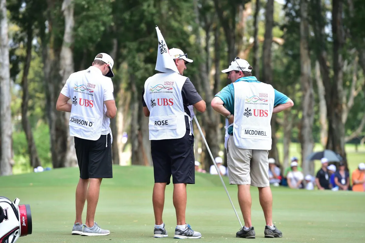 Caddies of top golfers Dustin Johnson, Justin Rose and Graeme McDowell at the 6th green on Day-1 of the UBS Hong Kong Open 2015, at Fanling on Thursday Oct 22, 2015. (Bill Cox/Epoch Times)