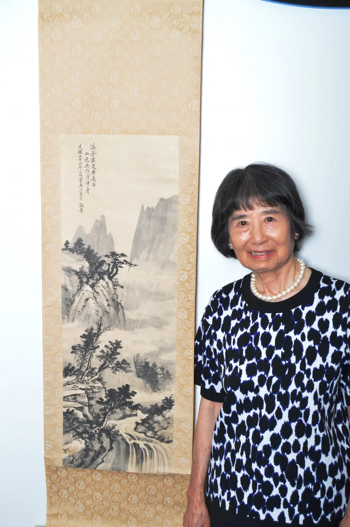 Dora Shu-fang Dien, professor emerita at California State University, next to a painting she completed in 1963 after only three months of instruction from Huang Junbi, the then teacher of Madame Chiang Kai-shek. (Courtesy of Dora Shu-fang Dien)