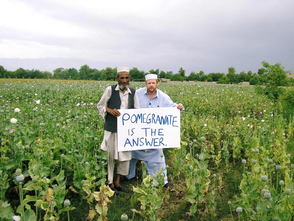 During his first visit to Afghanistan in 2007, James Brett walked into a poppy field to convince a farmer to switch to pomegranates. (Courtesy of Plant For Peace)