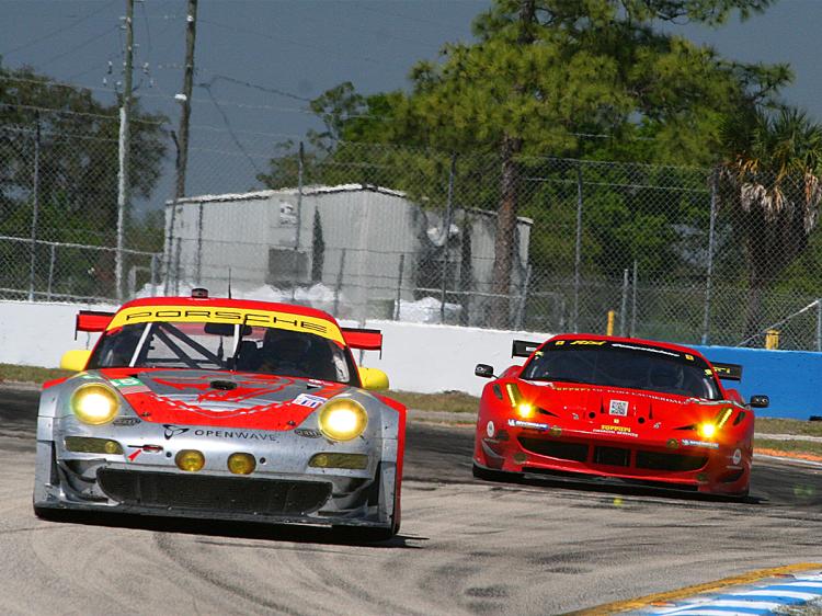 Classic GT battles: the Risi Ferrari 458 chases the Flying Lizard Porsche into Turn 11 at Sebring. (James Fish/The Epoch Times) Classic GT battles: the Risi Ferrari 458 chases the Flying Lizard Porsche into Turn 11 at Sebring. (James Fish/The Epoch Times)