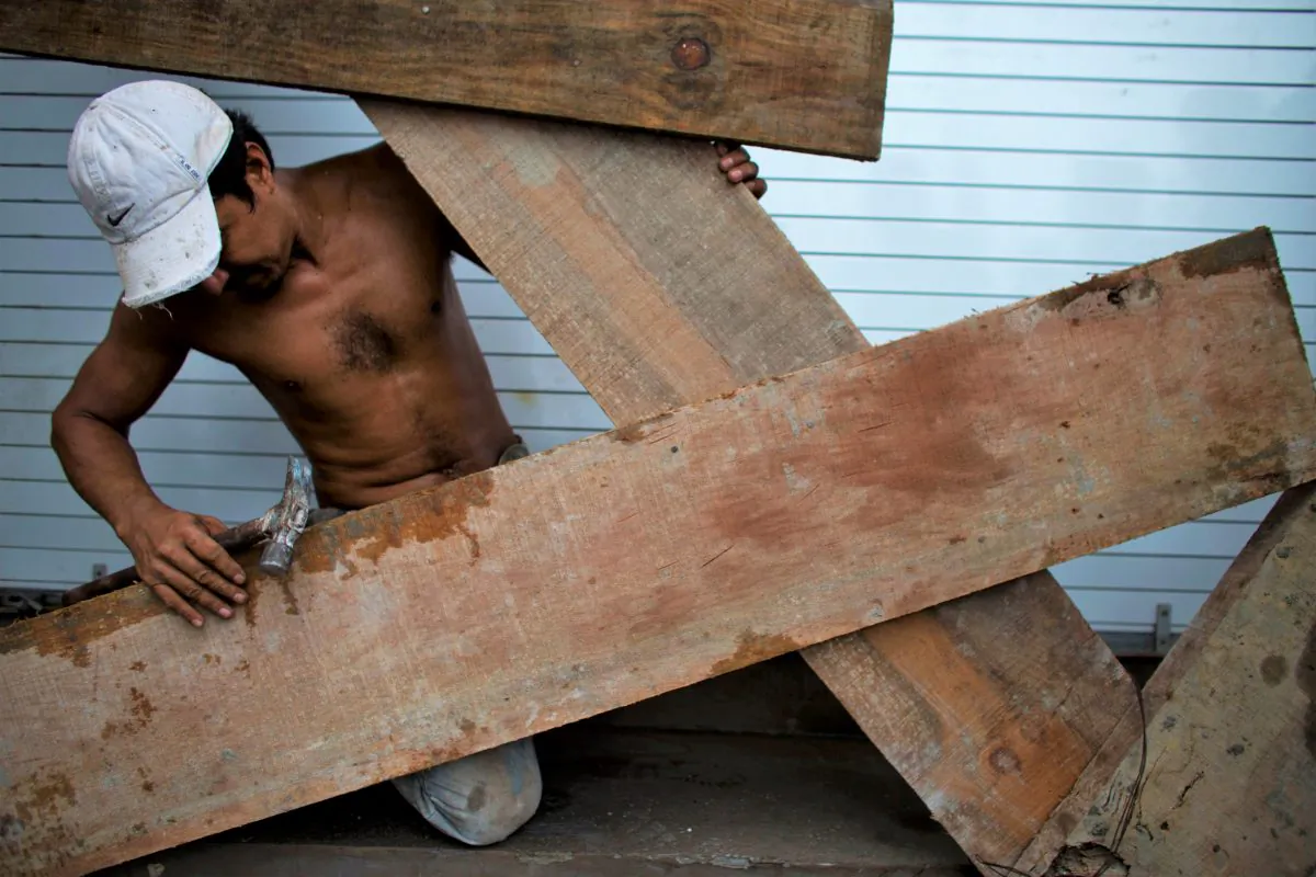 A worker boards up the front of a waterfront business, as residents prepare for the arrival of Hurricane Patricia in Puerto Vallarta, Mexico, on Oct. 23, 2015. (AP Photo/Rebecca Blackwell)