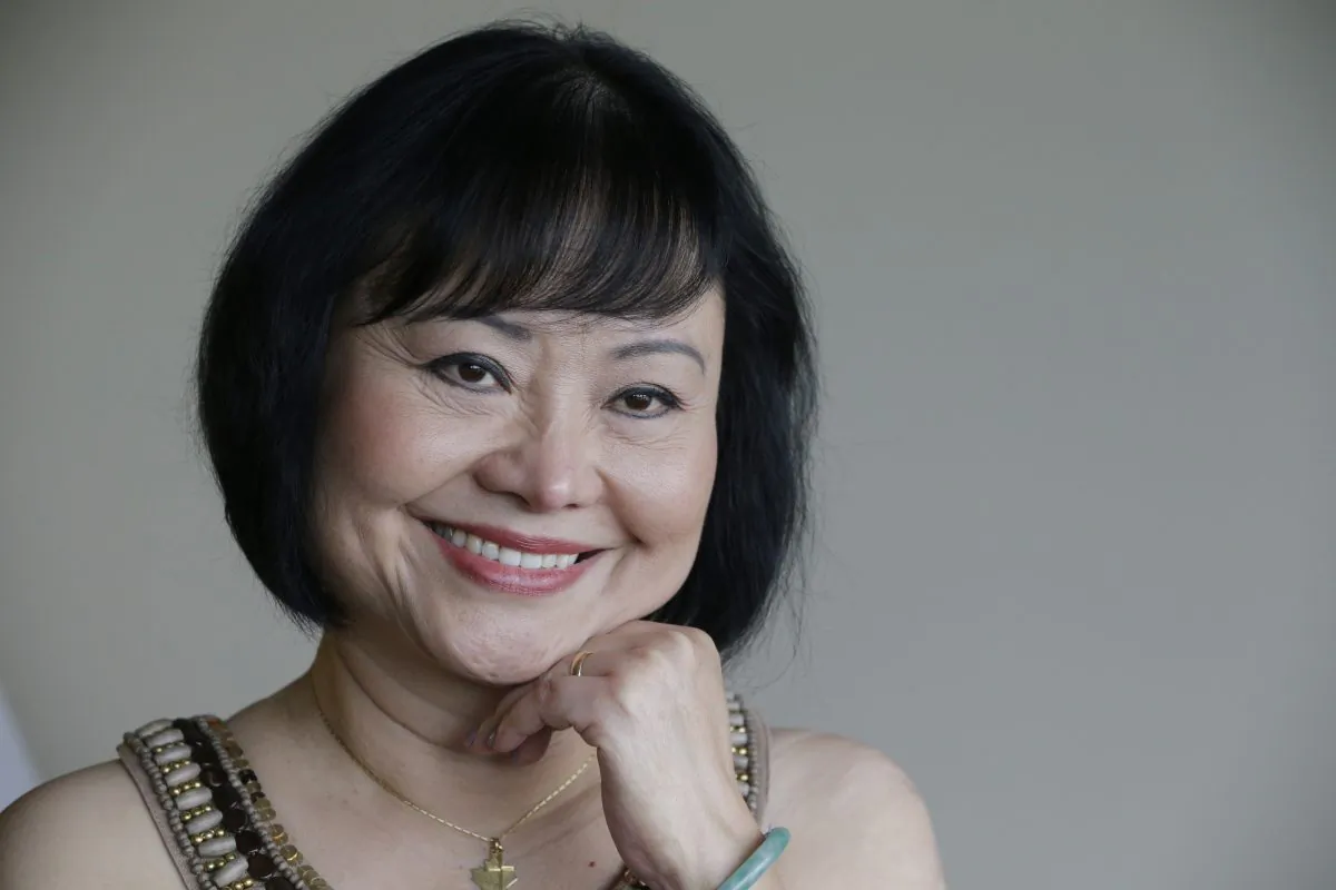 Kim Phuc poses for a photo at a hotel in Miami on Sept. 25, 2015. Phuc arrived from her home in Canada to undergo a series of laser treatments to reduce the scars and pain she has endured for 40 years following an attack on her village during the Vietnam war. (AP Photo/Nick Ut)
