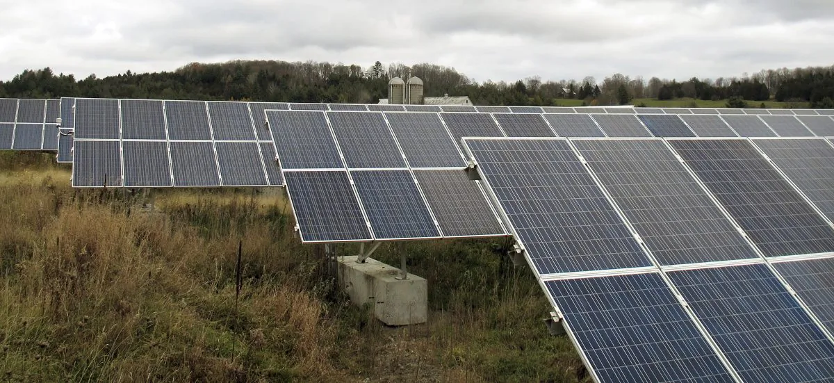 Solar panels that are part of a 100-kilowatt net metered project stand in a field on the McKnight Farm in East Montpelier, Vt., on Oct. 23, 2015. In 2014 Gov. Peter Shumlin signed a law at the farm which more than tripled the amount amount of electricity that can be sent to the electric grid from such projects. The amount of electricity being produced in the state by small net metered projects is growing faster than expected, and many utilities are nearing the cap established by the law. (Photo/Wilson Ring)