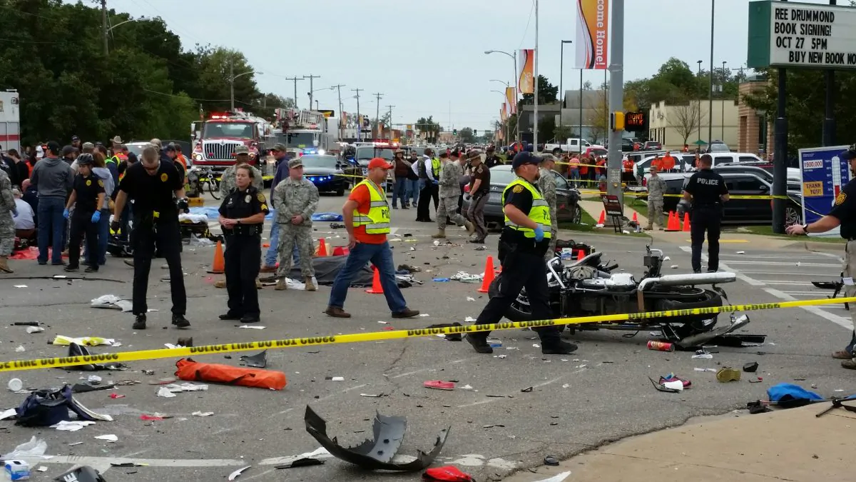 Emergency personnel respond after a vehicle crashed into a crowd of spectators during the Oklahoma State University homecoming parade, causing multiple injuries, in Stillwater, Oka., on Oct. 24, 2015. (David Bitton/The News Press via AP)