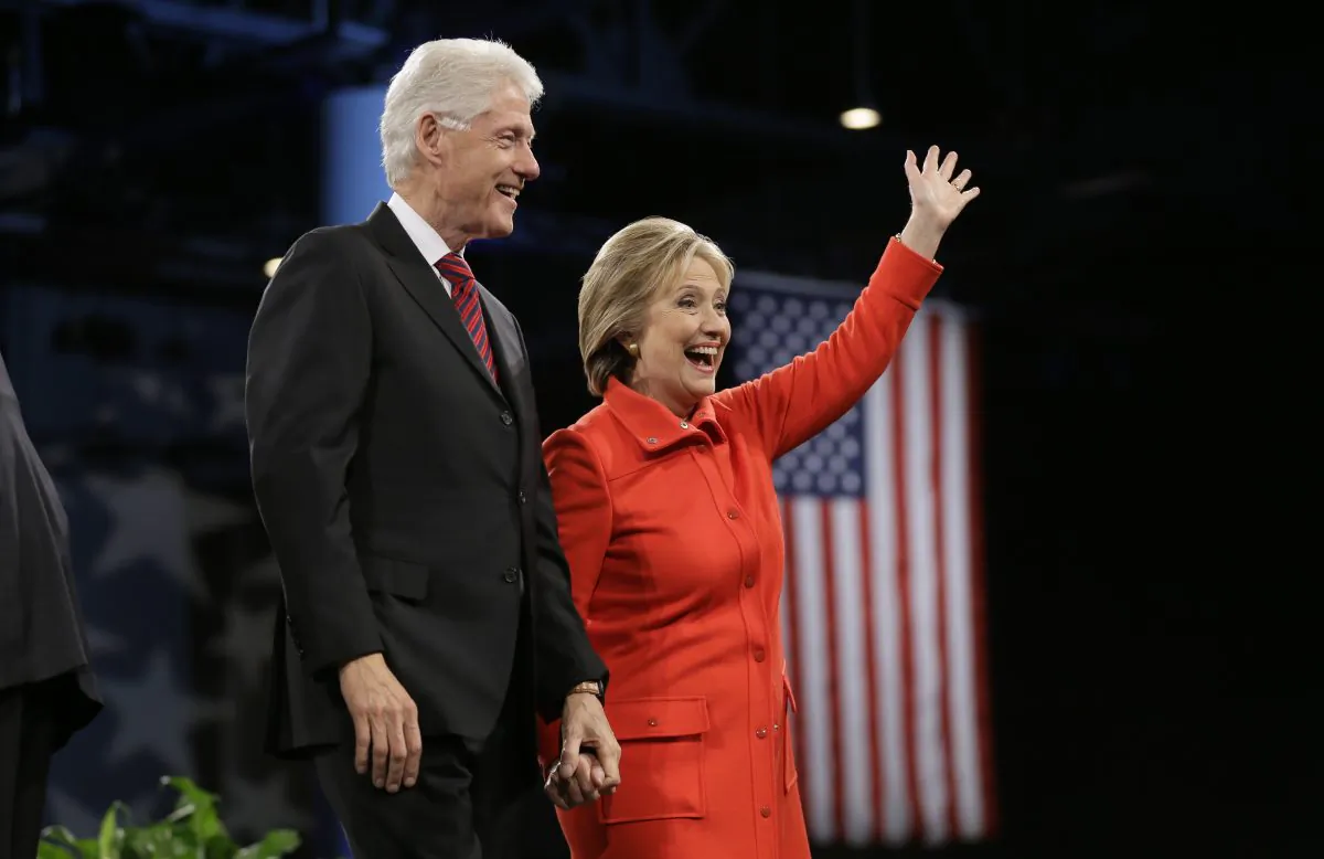 Former President Bill Clinton and his wife, Democratic presidential candidate Hillary Rodham Clinton, wave to supporters after the Iowa Democratic Party's Jefferson-Jackson fundraising dinner, Saturday, Oct. 24, 2015, in Des Moines, Iowa. (AP Photo/Charlie Neibergall)