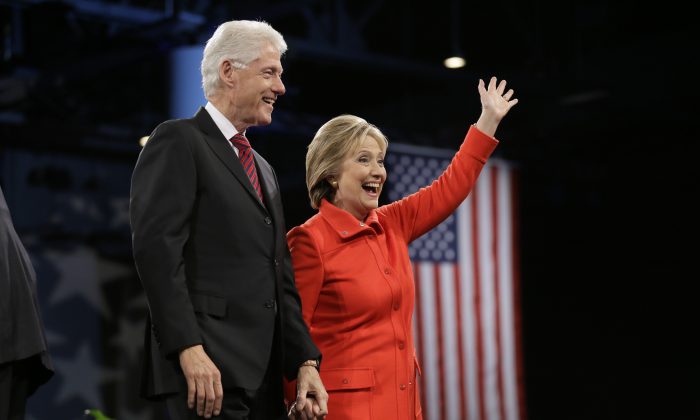 Former President Bill Clinton and his wife, Democratic presidential candidate Hillary Rodham Clinton, wave to supporters after the Iowa Democratic Party's Jefferson-Jackson fundraising dinner, Saturday, Oct. 24, 2015, in Des Moines, Iowa. (AP Photo/Charlie Neibergall)