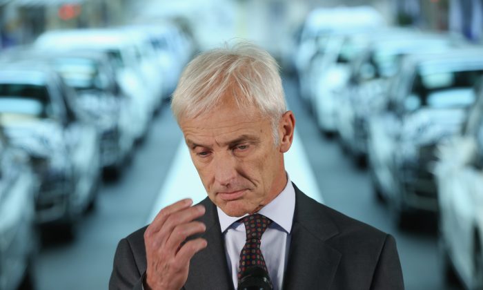 New Volkswagen Group Chairman Matthias Mueller speaks to the media with Volkswagen Work Council head Bernd Osterloh and Lower Saxony Governor Stephan Weil (both not pictured) while standing at the assembly line of the Volkswagen factory in Wolfsburg, Germany, on Oct. 21, 2015. (Photo by Sean Gallup/Getty Images)