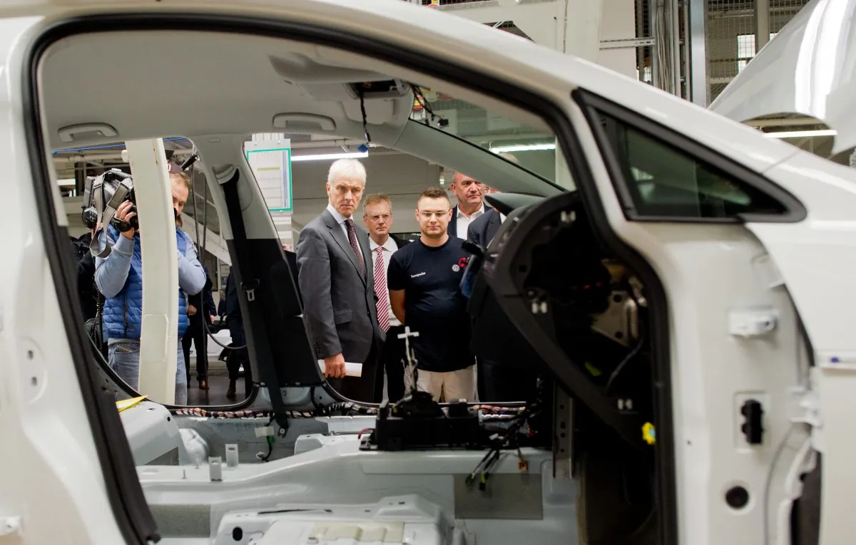 Volkswagen CEO Matthias Mueller (C) looks at the assembly line during a tour of the VW plant in Wolfsburg, Germany, on Oct. 21, 2015. (Julian Stratenschulte/AP)
