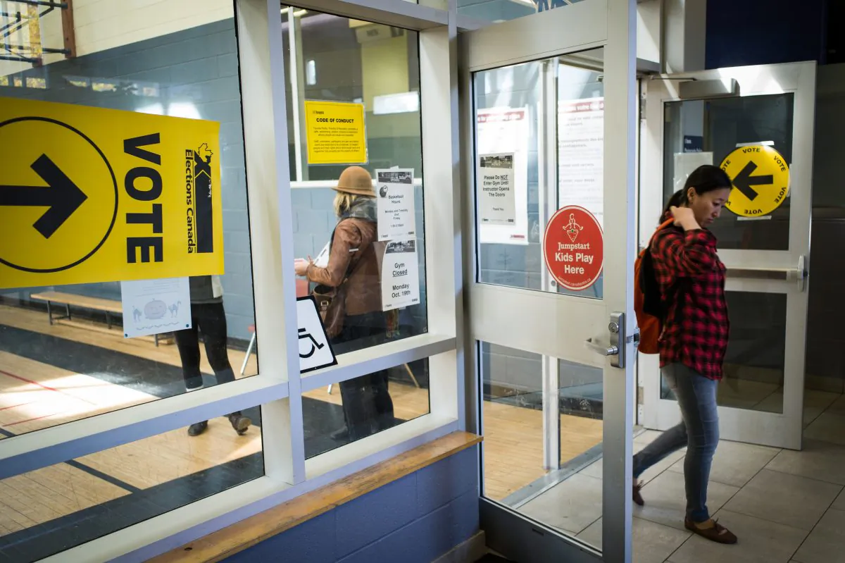 Voters make their way in and out of the polling station at the Mary McCormick Recreation Centre, in Toronto's Davenport riding, during the 42nd Canadian general election, in Toronto on Oct. 19, 2015. (Ian Willms/Getty Images)