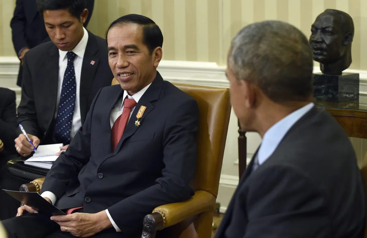 President Barack Obama listens as Indonesian President Joko Widodo speaks during their meeting in the Oval Office of the White House in Washington, D.C., on Oct. 26, 2015. This is Widodo's first visit to the U.S. since becoming president of Indonesia. (AP Photo/Susan Walsh)