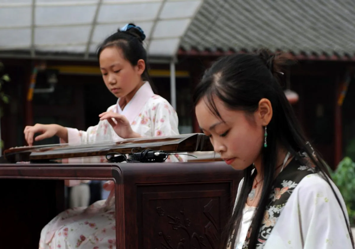 Young Chinese women play the classical, and complicated, guqin, a relative of the zither family. (China Photos/Getty Images)