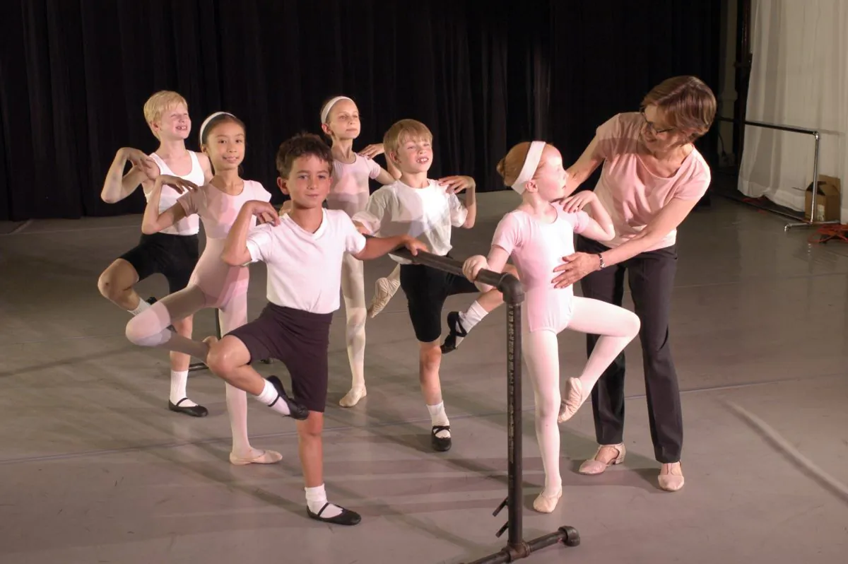 Diana Byer, founder and artistic director of the New York Theatre Ballet, correcting children's dance positions.
