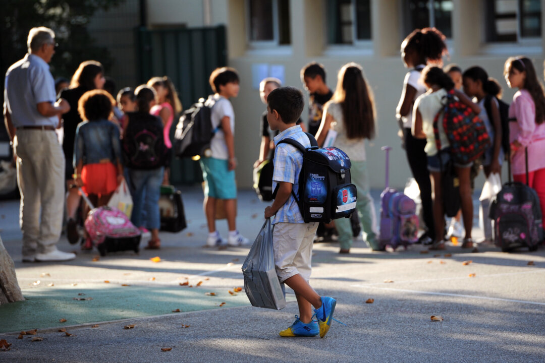 A pupil arrives in the courtyard of the Abbe de l'Epee elementary school on September 3, 2013 in Marseille, southern France, prior to enter her classroom on the first day of school. More than 12 million pupils went back to school today in France.(ANNE-CHRISTINE POUJOULAT/AFP/Getty Images)