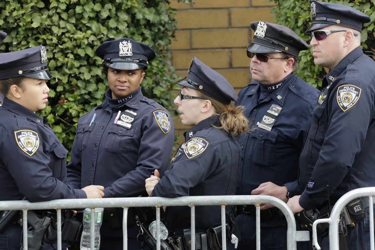 New York police officers arrive for the wake of fellow officer Randolph Holder at the Greater Allen A.M.E. Cathedral, Tuesday, Oct. 27, 2015, in the Queens borough of New York. Holder was shot and killed Tuesday, Oct. 20 while pursuing a suspect in the Harlem neighborhood of New York. The suspect was caught several blocks away with a gunshot wound to his leg. (AP Photo/Mark Lennihan)