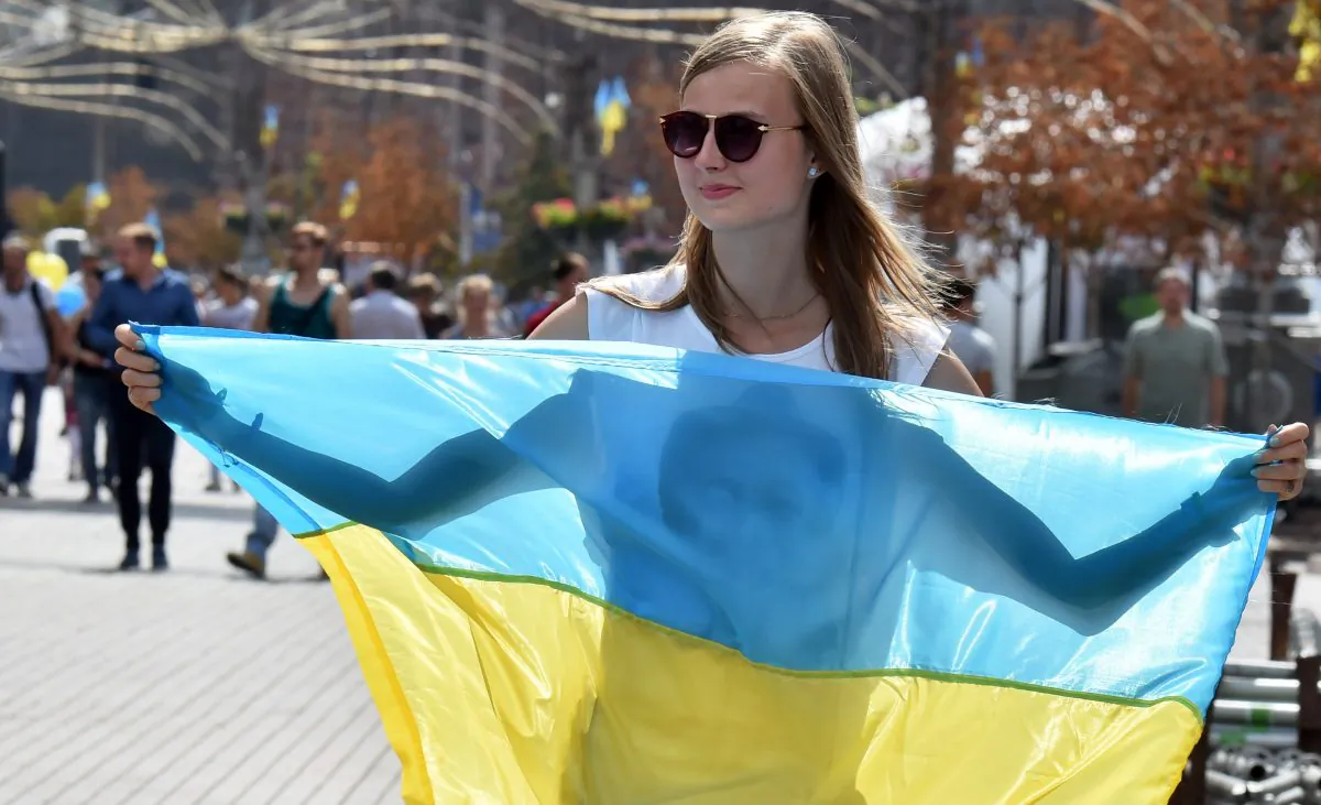 A young woman holds the Ukrainian flag during National Flag Day celebrations in Kiev on Aug. 23, 2015. (Sergei Supinsky/AFP/Getty Images)