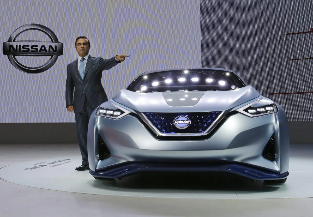 Carlos Ghosn, president and CEO of Nissan Motor Co., unveils the Nissan IDS Concept vehicle, which features self-driving and zero emission,  in the media preview for the Tokyo Motor Show in Tokyo, Wednesday, Oct. 28, 2015. (AP Photo/Shuji Kajiyama)