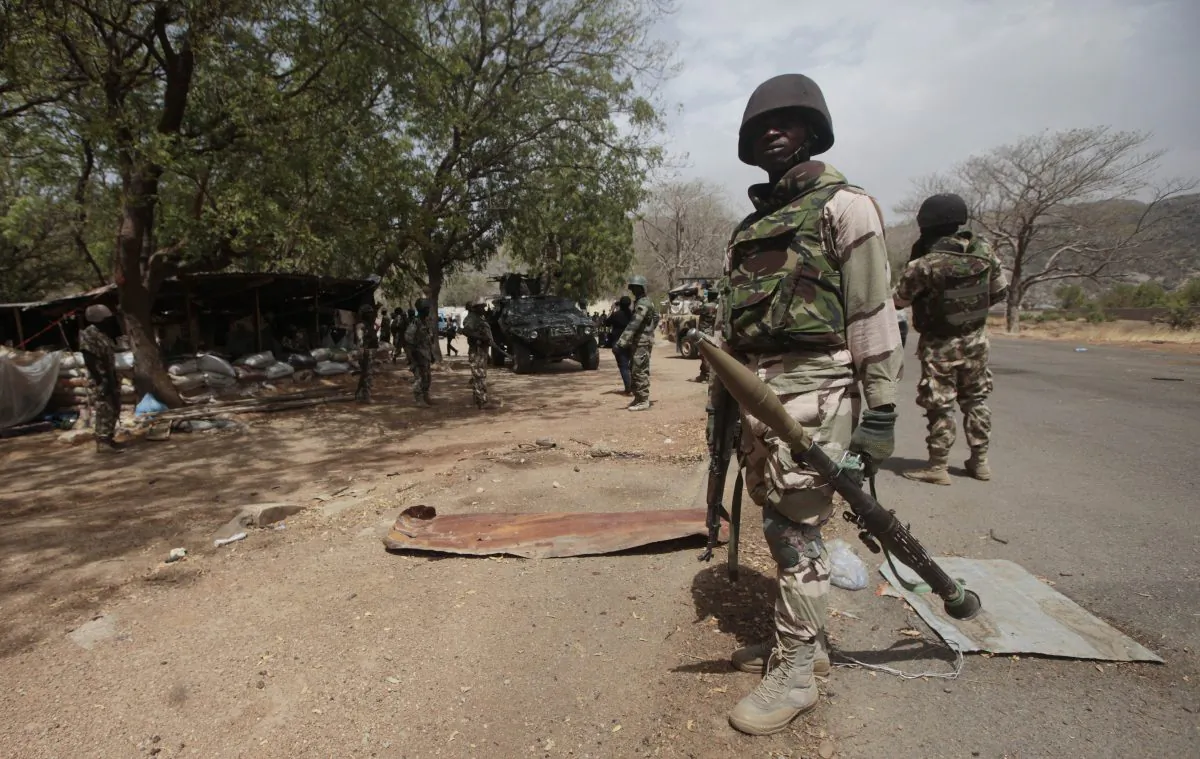 Nigerian soldiers man a checkpoint in Gwoza, Nigeria, a town newly liberated from Boko Haram, on April 8, 2015. (AP Photo/Lekan Oyekanmi)