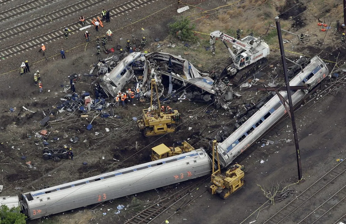 Emergency personnel work at the scene of a deadly train derailment in Philadelphia on May 13, 2015. The Amtrak train, headed to New York City, derailed and crashed in Philadelphia on May 12, killing at least six people and injuring dozens of others. Congress has passed a bill that delays for at least three years the mandate for railroads to put long-sought safety technology in place, and extends the government's authority to spend money on highway programs. (AP Photo/Patrick Semansky)