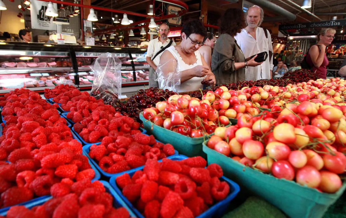 People shop at the Granville Island Public Market in Vancouver on July 26, 2010. A grading of Canada’s food system compared to 16 other OECD countries gives Canada a B-, with room for improvement in several areas. (The Canadian Press/Darryl Dyck)