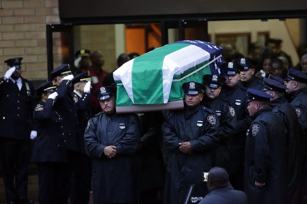 The casket bearing the remains of slain NYPD Officer Randolph Holder is taken out of Greater Allen A.M.E. Cathedral of New York, in the Queens Borough of New York City, on Oct. 28, 2015. Holder, 33, was gunned down while chasing a suspect in East Harlem last week, the fourth officer to be fatally shot in the line of duty in New York City in the last 10 months. Tyrone Howard was taken into custody a few blocks away and has been charged with murder and robbery. Holder will be buried in Guyana. (Spencer Platt/Getty Images)