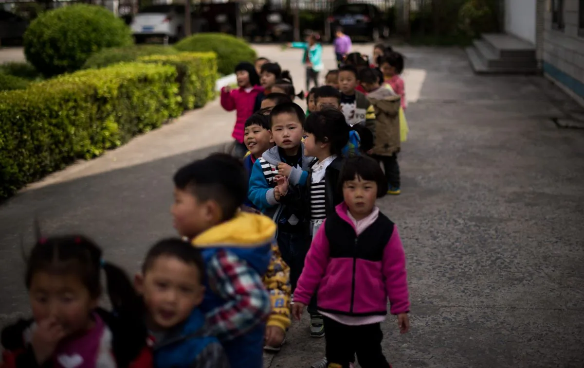 Children in the schoolyard of the once-bustling Technical Secondary School in Rudong, Jiangsu Province, on April 17, 2015. (Johannes Eisele/AFP/Getty Images)