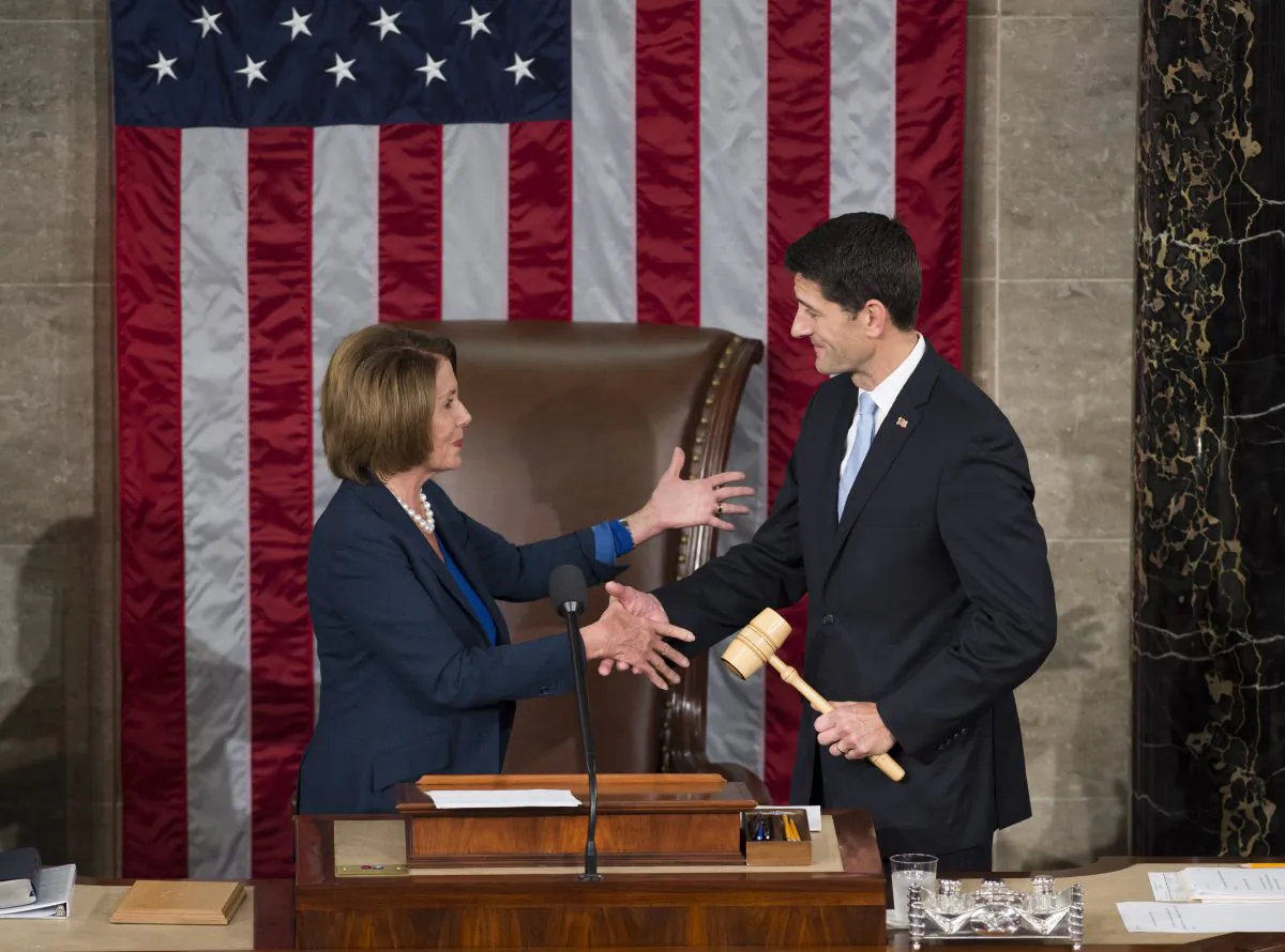 Paul Ryan, Republican of Wisconsin, receives the Speaker's gavel from House Democratic Leader Nancy Pelosi of California after becoming the new Speaker of the House in the House Chamber at the US Capitol, on Oct. 29, 2015. (Saul Loeb/AFP/Getty Images)
