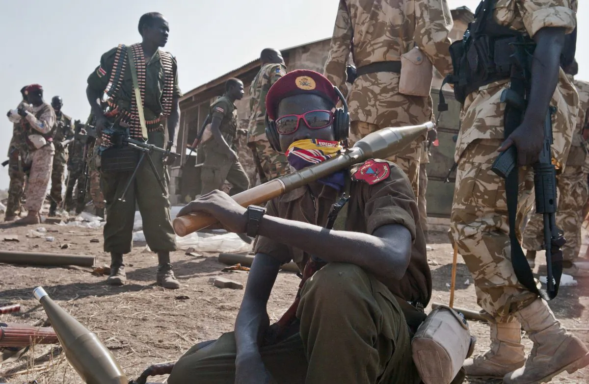 In this Monday, Jan. 13, 2014 file photo, South Sudanese government soldiers wait to board trucks and pickups, to head to the frontlines to reinforce other government forces already fighting rebel forces near the town of Bor, as they prepare to leave from the outskirts of Juba, South Sudan. (AP Photo/Jake Simkin)