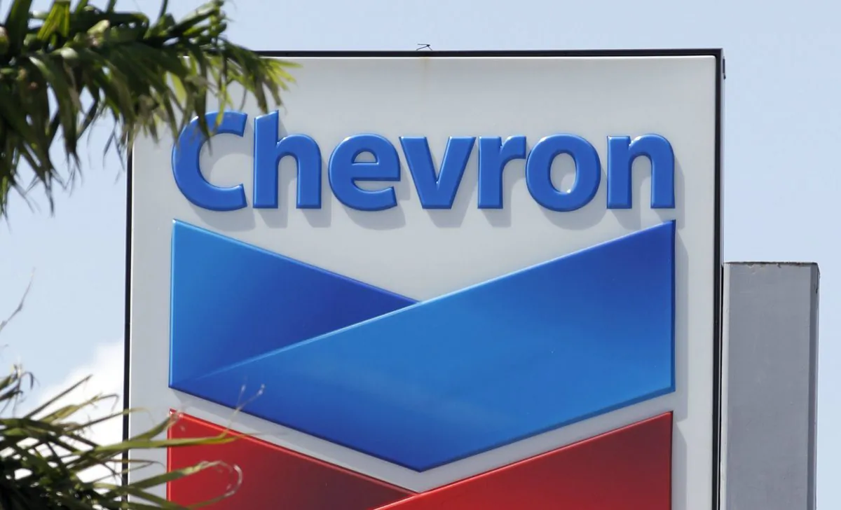 A Chevron sign in Miami on Aug. 20, 2012. Chevron Corp. is cutting up to 7,000 jobs as it deals with lower oil prices that are cutting deeply into profit. The company said on Oct. 30, 2015, that it would cut capital and exploratory spending next year by one-fourth, with further cuts in 2017 and 2018 depending on the oil industry's condition then. (AP Photo/Alan Diaz)