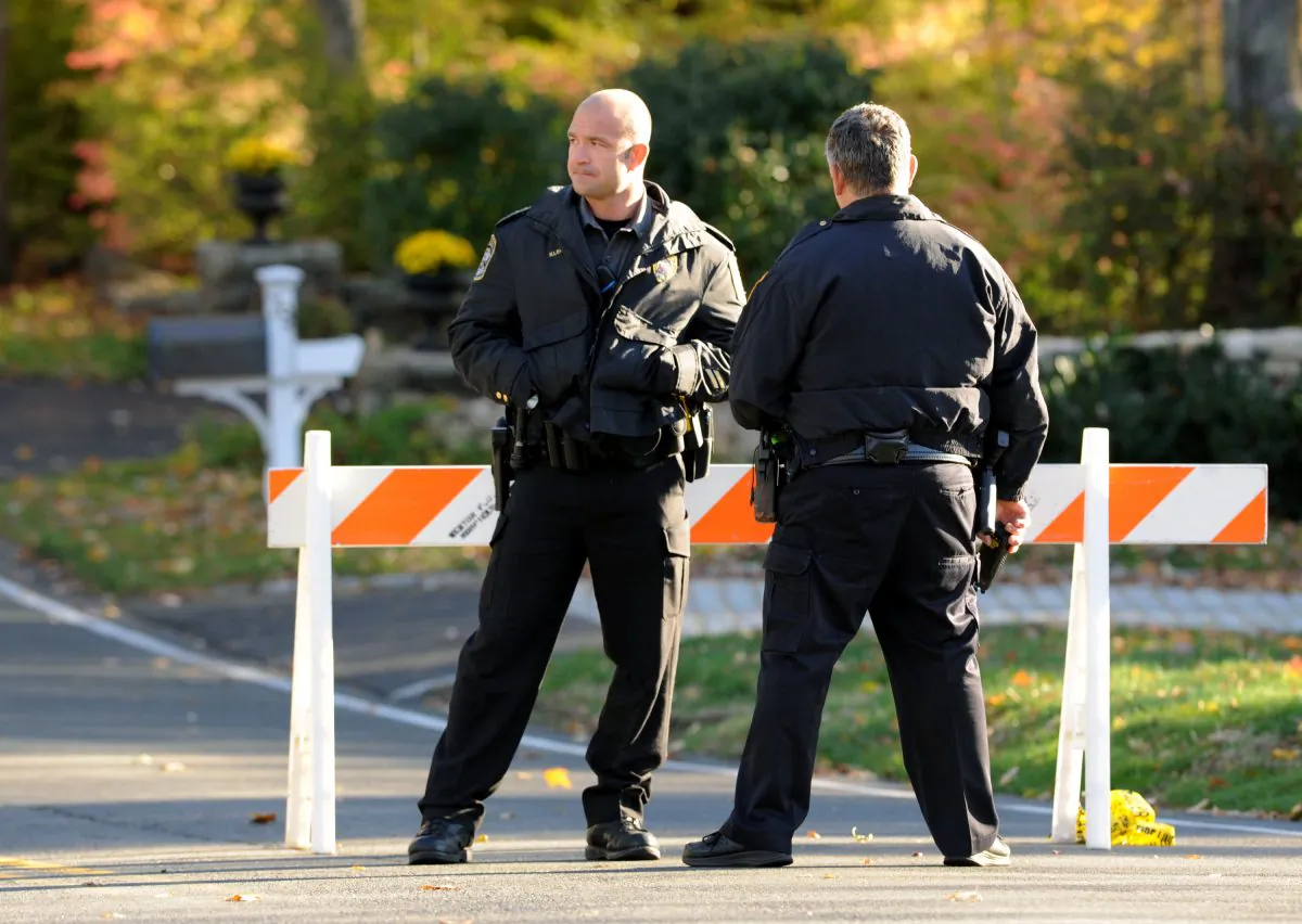 Police officers stand at the scene of a search around a home in Weston, Conn., on Oct. 30, 2015, reportedly belonging to a friend of Kyle Navin. Possible human remains were found during the search and may be linked to the disappearance of missing Easton couple, Jeanette and Jeffery Navin, Kyle Navin's parents. (Cathy Zuraw/Hearst Connecticut Media via AP)