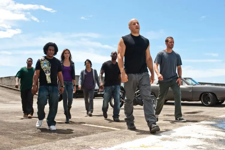 (L-R) Don Omar, Tego Calderon, Gal Gadot, Sung Kang, Tyrese Gibson, and Vin Diesel from the action thriller 'Fast Five.' (Courtesy of Jaimie Trueblood/The Universal Studios)