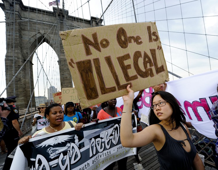 A coalition of immigrant groups and their supporters march across the Brooklyn Bridge in New York on July 29, 2010, calling for a permanent repeal of Arizona's controversial immigration law. (Timothy A. Clary/ Getty Images) A coalition of immigrant groups and their supporters march across the Brooklyn Bridge in New York on July 29, 2010, calling for a permanent repeal of Arizona's controversial immigration law. (Timothy A. Clary/ Getty Images)