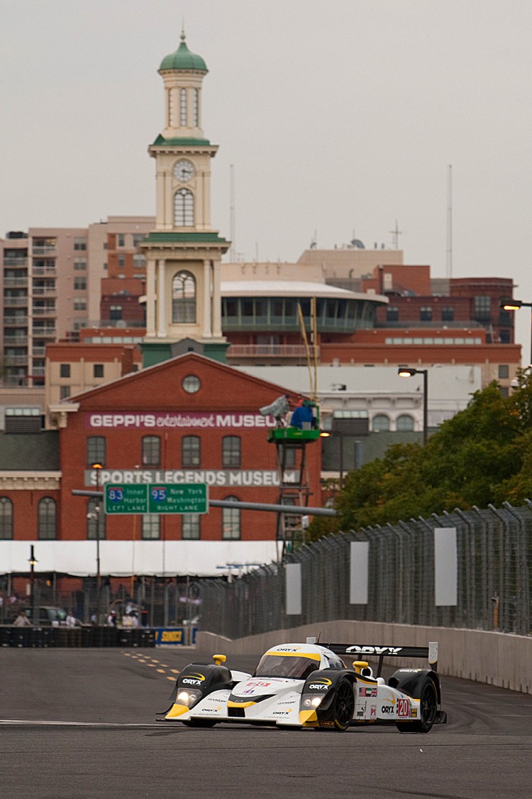 Steven Kane in the #20 Oryx Loal Mazda flies past some of the Baltimore scenery which gives the course a unique flavor. (Regis Lefebure/Dyson Racing) Steven Kane in the #20 Oryx Loal Mazda flies past some of the Baltimore scenery which gives the course a unique flavor. (Regis Lefebure/Dyson Racing)