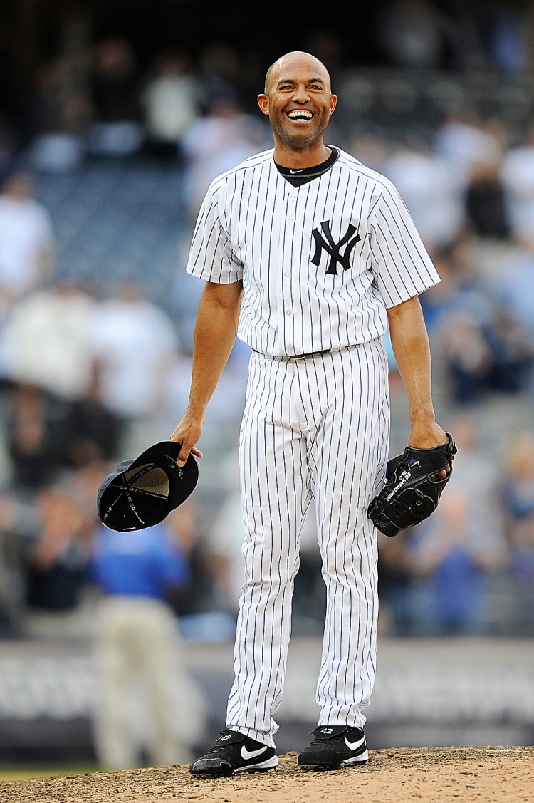 ALONE AT THE TOP: Not sure how to celebrate such an individual achievement, Yankees' closer Mariano Rivera is led out to the mound after his record-breaking day by longtime battery-mate Jorge Posada for a long standing ovation. (Patrick Mcdermott/Getty Images) ALONE AT THE TOP: Not sure how to celebrate such an individual achievement, Yankees' closer Mariano Rivera is led out to the mound after his record-breaking day by longtime battery-mate Jorge Posada for a long standing ovation. (Patrick Mcdermott/Getty Images)