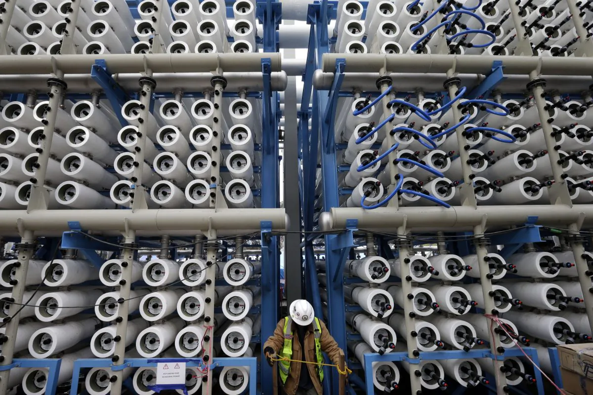 A worker climbs stairs among some of the 2,000 pressure vessels that will be used to convert seawater into fresh water through reverse osmosis in the western hemisphere's largest desalination plant in Carlsbad, Calif., on March 11, 2015. As California endures the worst drought in its recorded history, some are turning to the sea for relief. The Carlsbad Desalination Project, scheduled to start operations in late 2015, is expected to provide 50 million gallons of fresh drinking water a day. (AP Photo/Gregory Bull)