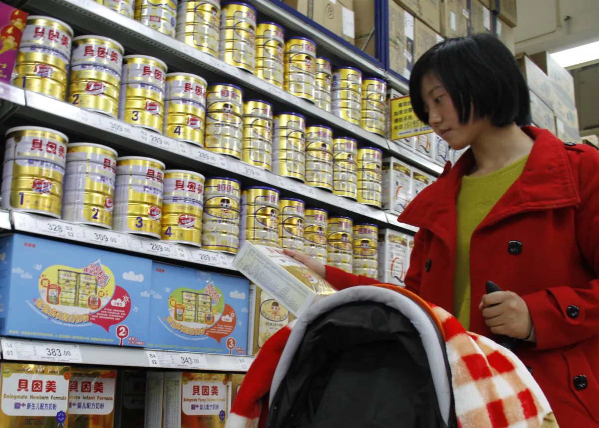 A woman looks at baby milk powder in a supermarket in Nanjing, east China's Jiangsu Province, on March 29, 2013. (STR/AFP/Getty Images)