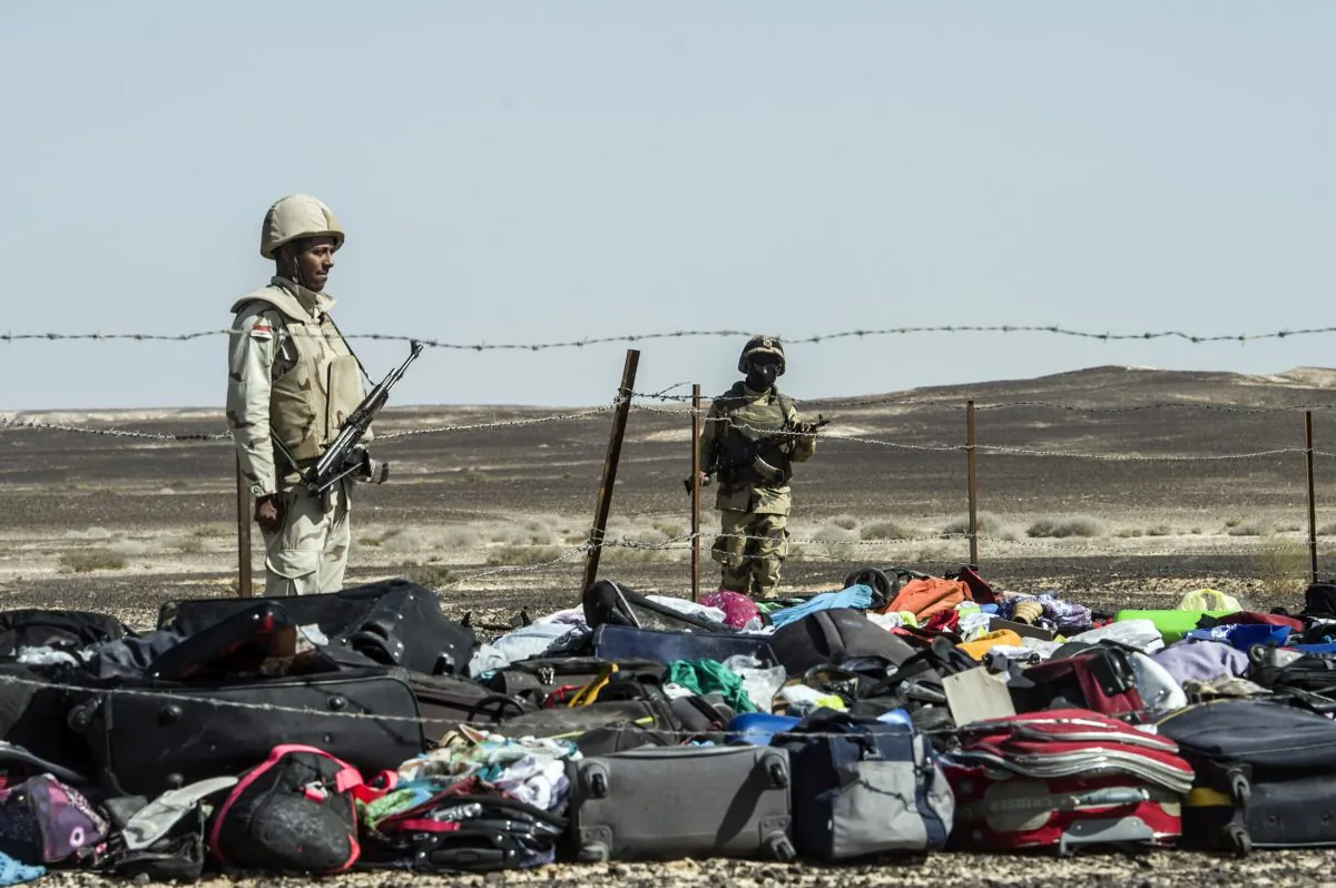 Egyptian army soldiers next to the luggage and belongings of passengers of the A321 Russian airliner piled up at the site of the crash in Wadi al-Zolomat, a mountainous area in Egypt's Sinai Peninsula, on Nov. 1, 2015. (Khaled Desouki/AFP/Getty Images)